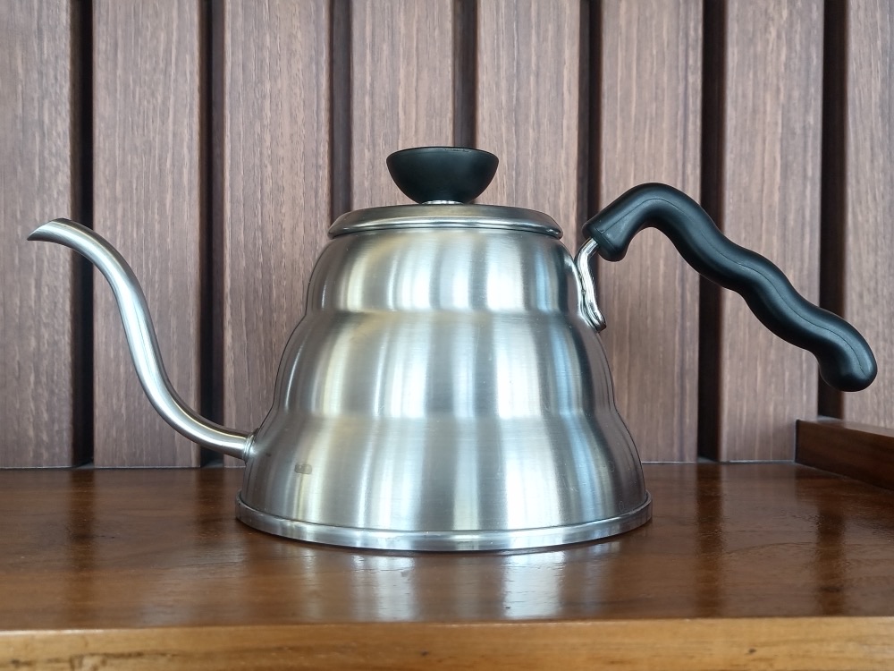 The gooseneck kettle — here Hario’s own Buono — exists to make pour rate and placement controllable. Photograph: Fumikas Sagisavas, CC0, via Wikimedia Commons.