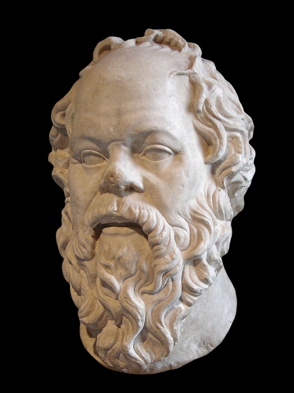 Socrates, Roman marble after a Greek bronze by Lysippos — the Louvre. He was, by every account including his own, remarkably ugly: snub nose, bulging eyes, the face of a satyr. Athens never forgave him for showing them that beauty was elsewhere.